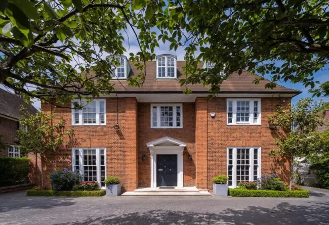 Symmetrical Red Brick Mansion with White-Framed Windows