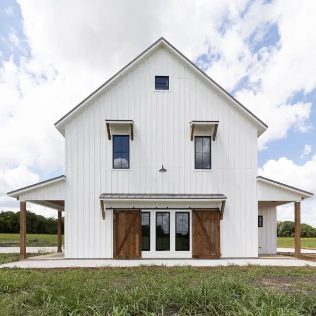 White Barndominium with Wooden Accents